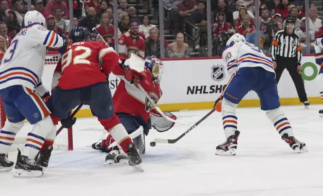 Florida Panthers goaltender Sergei Bobrovsky (72) defends a shot on goal by Edmonton Oilers right wing Corey Perry (90) during the third period of Game 4 of the NHL hockey Stanley Cup Final Thursday, June 12, 2025, in Sunrise, Fla. (AP Photo/Lynne Sladky)