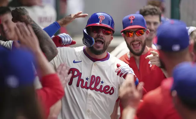 Philadelphia Phillies' Kyle Schwarber celebrates with teammates after hitting a home run against Chicago Cubs pitcher Ben Brown during the third inning of a baseball game Wednesday, June 11, 2025, in Philadelphia. (AP Photo/Matt Slocum)