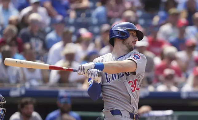 Chicago Cubs' Kyle Tucker follows through after hitting a run-scoring gourd out against Philadelphia Phillies pitcher Max Lazar during the eighth inning of a baseball game Wednesday, June 11, 2025, in Philadelphia. (AP Photo/Matt Slocum)