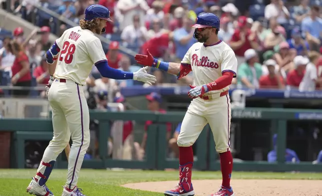 Philadelphia Phillies' Kyle Schwarber, right, celebrates with Alec Bohm after hitting a home run against Chicago Cubs pitcher Ben Brown during the third inning of a baseball game Wednesday, June 11, 2025, in Philadelphia. (AP Photo/Matt Slocum)
