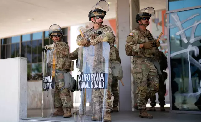 National Guard stand guard near the metropolitan detention center Monday, June 9, 2025, in downtown Los Angeles. (AP Photo/Eric Thayer)