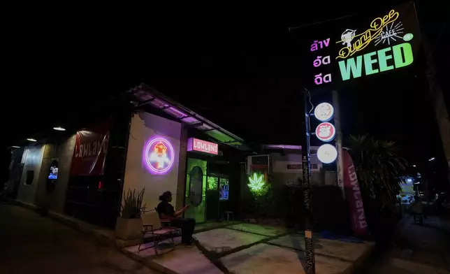 FILE--A customer sits outside a cannabis shop in Kanchanaburi province, west of Bangkok, Thailand, July 16, 2024. (AP Photo/Sakchai Lalit, File)