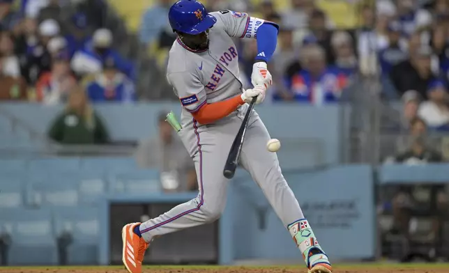 New York Mets' Ronny Mauricio grounds into a double play during the second inning of a baseball game against the Los Angeles Dodgers, Tuesday, June 3, 2025, in Los Angeles. (AP Photo/Jayne Kamin-Oncea)