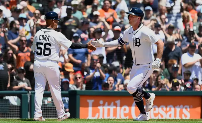 Detroit Tigers' Kerry Carpenter, right, is congratulated by third base coach Joey Cora after hitting a home run during the third inning of a baseball game against the Minnesota Twins, Saturday, June 28, 2025, in Detroit. (AP Photo/Jose Juarez)