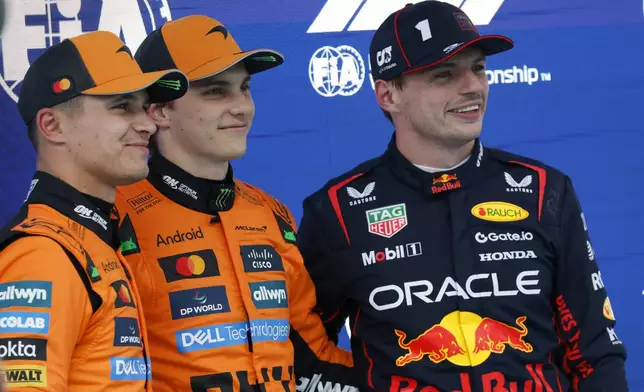 McLaren driver Oscar Piastri of Australia, centre, celebrates his pole position with McLaren driver Lando Norris of Britain, left, and Red Bull driver Max Verstappen of the Netherlands after the qualifying session ahead of the Spanish Grand Prix Formula One race at the Barcelona Catalunya racetrack in Montmelo, near Barcelona, Spain, Saturday, May 31, 2025. (AP Photo/Joan Monfort)
