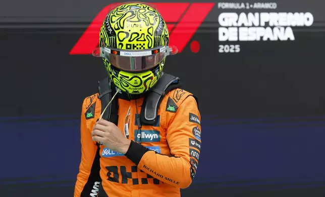 McLaren driver Oscar Piastri of Australia celebrates his pole position after the qualifying session ahead of the Spanish Grand Prix Formula One race at the Barcelona Catalunya racetrack in Montmelo, near Barcelona, Spain, Saturday, May 31, 2025. (AP Photo/Joan Monfort)