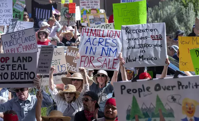 A few thousand people rally outside the Eldorado Hotel to protest against the sale of public lands by the Trump administration, during the Western Governors Association meeting in Santa Fe, N.M., Monday, June 23, 2025. (Eddie Moore/The Albuquerque Journal via AP)