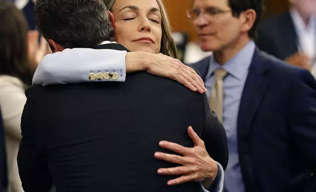 Karen Read hugs lawyer Alan Jackson after a not guilty verdict of second-degree murder is read in Norfolk Superior Court, Wednesday, June 18, 2025, in Dedham, Mass. (Greg Derr/The Patriot Ledger via AP, Pool)