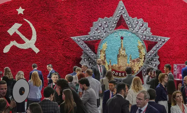 Guests and participants walk in front of a model of the Order of Victory on the sidelines of the St. Petersburg International Economic Forum in St. Petersburg, Russia, Wednesday, June 18, 2025. (AP Photo/Dmitri Lovetsky)