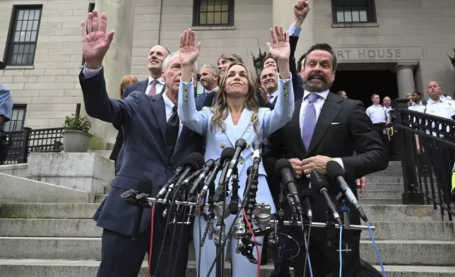 Karen Read, center, waves to supporters as she speaks after she was found not guilty of second-degree murder on Wednesday, June 18, 2025, in Dedham, Mass. (AP Photo/Josh Reynolds)