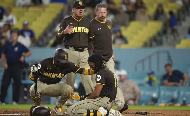 San Diego Padres manager Mike Shildt, center, yells toward the Los Angeles Dodgers dugout after Fernando Tatis Jr., lower right, was hit by a pitch during the ninth inning of a baseball game Thursday, June 19, 2025, in Los Angeles. (AP Photo/Mark J. Terrill)