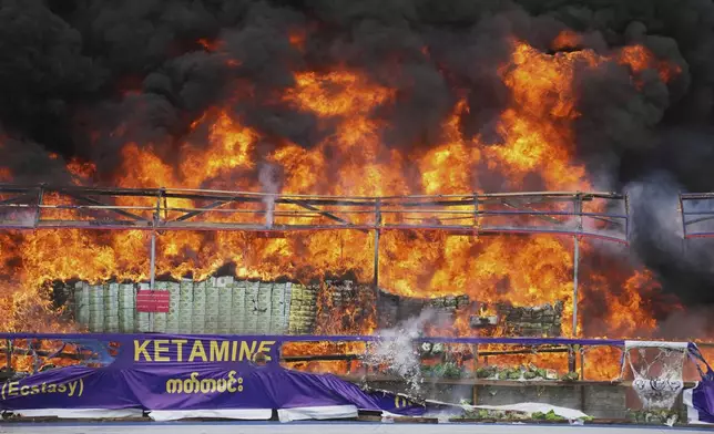 Smoke and flame rise from burning illegal narcotics during a destruction ceremony to mark International Day against Drug Abuse and Illicit Trafficking, on the outskirts of Yangon, Myanmar, Thursday, June 26, 2025. (AP Photo/Thein Zaw)