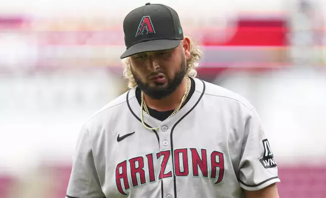 Arizona Diamondbacks pitcher Juan Morillo walks to the dugout during the seventh inning of a baseball game against the Cincinnati Reds that was suspended Friday because of rain and resumed, Saturday, June 7, 2025, in Cincinnati. (AP Photo/Jeff Dean)