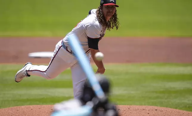 Atlanta Braves pitcher Grant Holmes (66) works against Colorado Rockies' Jordan Beck (27) in the first inning of a baseball game, Sunday, June 15, 2025, in Atlanta. (AP Photo/Mike Stewart)