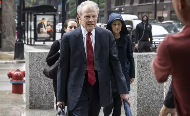 Flanked by attorneys and supporters, Illinois' former House Speaker Michael Madigan walks into the Dirksen Federal Courthouse for his sentencing hearing, Friday, June 13, 2025, in Chicago. (Ashlee Rezin/Chicago Sun-Times via AP)