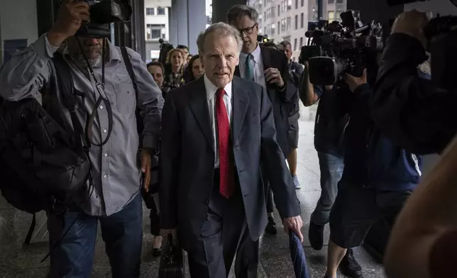 Flanked by attorneys and supporters, Illinois' former House Speaker Michael Madigan walks into the Dirksen Federal Courthouse for his sentencing hearing, Friday, June 13, 2025, in Chicago. (Ashlee Rezin/Chicago Sun-Times via AP)
