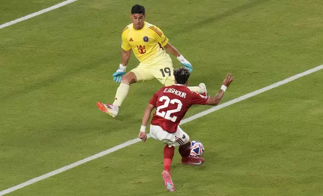 Inter Miami's Oscar Ustari comes out to save at the feet of Al Ahly's Emam Ashour during the Club World Cup group A soccer match between Al Ahly and Inter Miami in Miami, Fla., Saturday, June 14, 2025. (AP Photo/John Raoux)