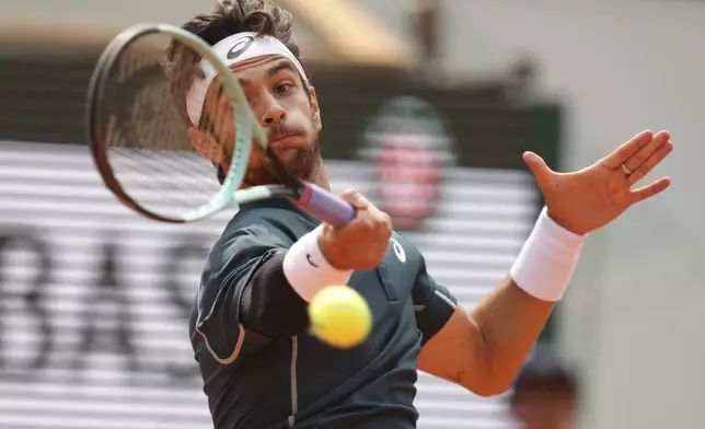 Italy's Lorenzo Musetti plays a shot against Frances Tiafoe of the U.S. during their quarterfinal match of the French Tennis Open at the Roland-Garros stadium in Paris, Tuesday, June 3, 2025. (AP Photo/Aurelien Morissard)