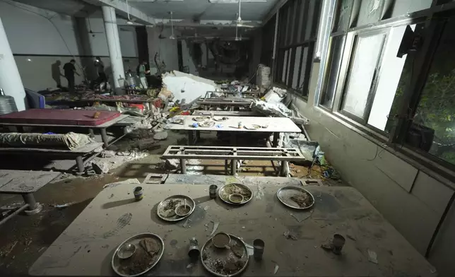 Inside view of a canteen building where the tail of an airplane stuck after it crashed in India's northwestern city of Ahmedabad in Gujarat state, India, Thursday, June 12, 2025. (AP Photo/Ajit Solanki)