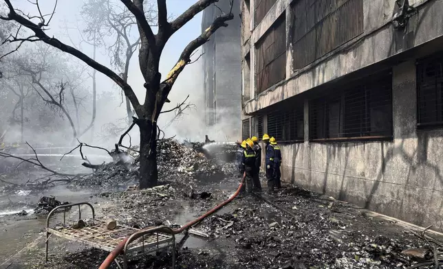 Firefighters work at the site of an airplane that crashed in India's northwestern city of Ahmedabad in Gujarat state, Thursday, June 12, 2025. (AP Photo/Ajit Solanki)