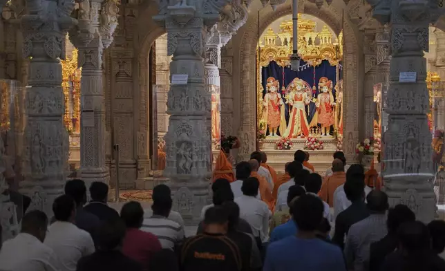 People attend prayers at the BAPS Shri Swaminarayan Mandir, the Hindu Neasden Temple, London, Thursday, June 12, 2025, for the victims of the Air India aircraft crash in Ahmedabad, India. (AP Photo/Alberto Pezzali)