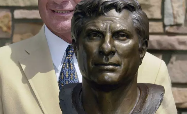 FILE - Former Miami Dolphins great Nick Buoniconti holds his bronze bust after enshrinement into the Pro Football Hall of Fame in Canton, Ohio, Aug. 4, 2001. (AP Photo/Mark Duncan)