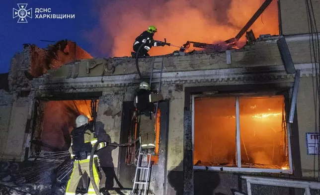 In this photo provided by the Ukrainian Emergency Services on Thursday, June 12, 2025, rescue workers put out a fire of a building which was damaged by a Russian strike in Kharkiv, Ukraine. (Ukrainian Emergency Services via AP)