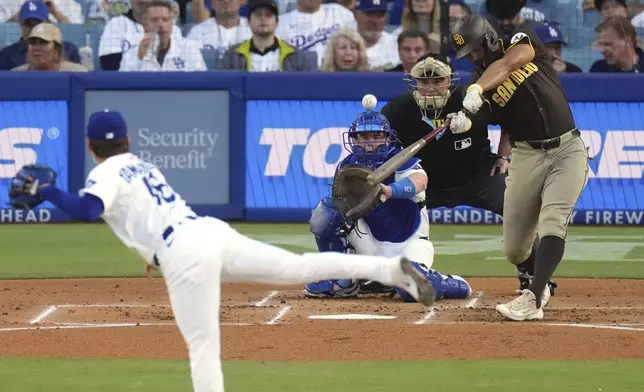 San Diego Padres' Xander Bogaerts hits a solo home run as Los Angeles Dodgers starting pitcher Yoshinobu Yamamoto, left, watches along with catcher Will Smith, during the XX inning of a baseball game Thursday, June 19, 2025, in Los Angeles. (AP Photo/Mark J. Terrill)