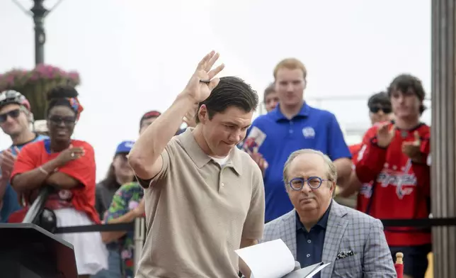 Washington Capitals forward T.J. Oshie acknowledges the crowd at Washington Harbour as he announces his retirement from the NHL, Monday, June 9, 2025, in Washington. (AP Photo/Rod Lamkey, Jr.)