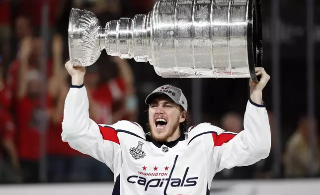 FILE - Washington Capitals right wing T.J. Oshie hoists the Stanley Cup after the Capitals defeated the Golden Knights 4-3 in Game 5 of the NHL hockey Stanley Cup Finals Thursday, June 7, 2018, in Las Vegas. (AP Photo/John Locher, File)