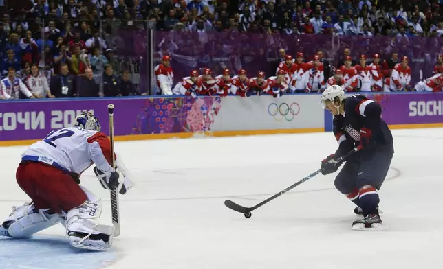 FILE - USA forward T.J. Oshie prepares to take a shot against Russia goaltender Sergei Bobrovski in an overtime shootout during a men's ice hockey game at the 2014 Winter Olympics, Saturday, Feb. 15, 2014, in Sochi, Russia. Oshie scored the winning goal and the USA won 3-2. (AP Photo/Julio Cortez, File)