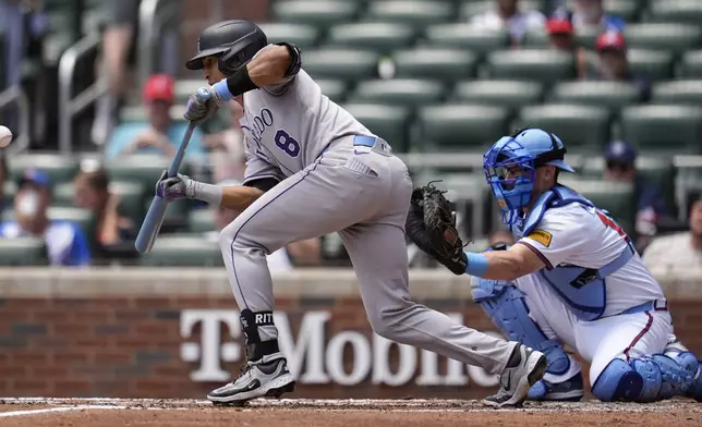 Colorado Rockies' Ryan Ritter (8) bunts against the Atlanta Braves in the third inning of a baseball game, Sunday, June 15, 2025, in Atlanta. (AP Photo/Mike Stewart)