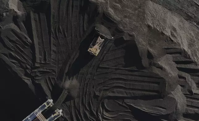 A bulldozer moves coal Thursday, April 10, 2025, in Princeton, Ind. (AP Photo/Joshua A. Bickel)