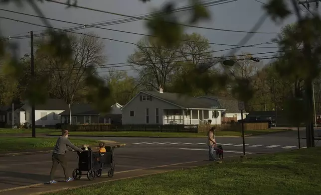 Kirt Ethridge, left, walks with his wife, Grace, right, and their daughters Thursday, April 10, 2025, in Evansville, Ind. (AP Photo/Joshua A. Bickel)