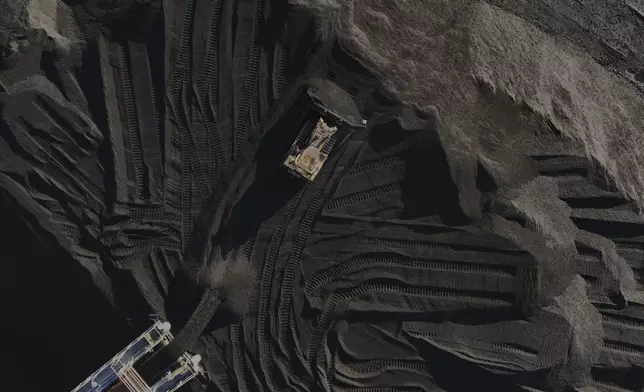 A bulldozer moves coal Thursday, April 10, 2025, in Princeton, Ind. (AP Photo/Joshua A. Bickel)