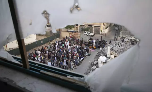 Palestinians offer Eid al-Adha prayers beside the ruins of a mosque destroyed by Israeli bombardment, in Deir al-Balah, Gaza, Friday, June 6, 2025.(AP Photo/Abdel Kareem Hana)