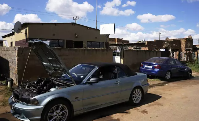 Cars to be repaired are parked outside the workshop of Themba Maseko, a 39-year-old mechanic, in Brakpan, east of Johannesburg, South Africa, Wednesday, April 30, 2025. (AP Photo/Themba Hadebe)