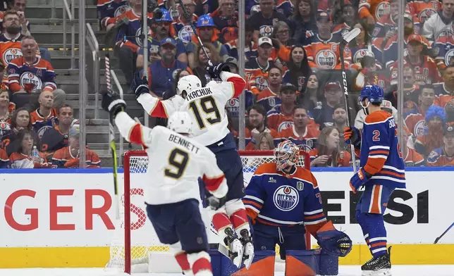 Florida Panthers' Matthew Tkachuk (19) and Sam Bennett (9) celebrate Dmitry Kulikov's goal against Edmonton Oilers goalie Stuart Skinner as Oilers' Evan Bouchard (2) looks on during the second period in Game 2 of the NHL hockey Stanley Cup Finals, in Edmonton, Alberta, Friday, June 6, 2025. (Darryl Dyck/The Canadian Press via AP)