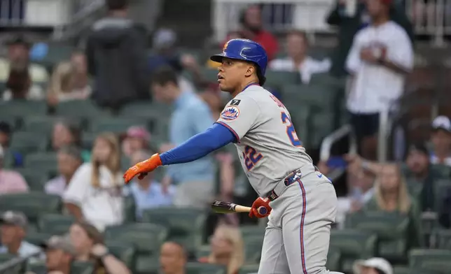 New York Mets' Juan Soto (22) watches his solo home run in the first inning of a baseball game against the Atlanta Braves, Tuesday, June 17, 2025, in Atlanta. (AP Photo/Brynn Anderson)