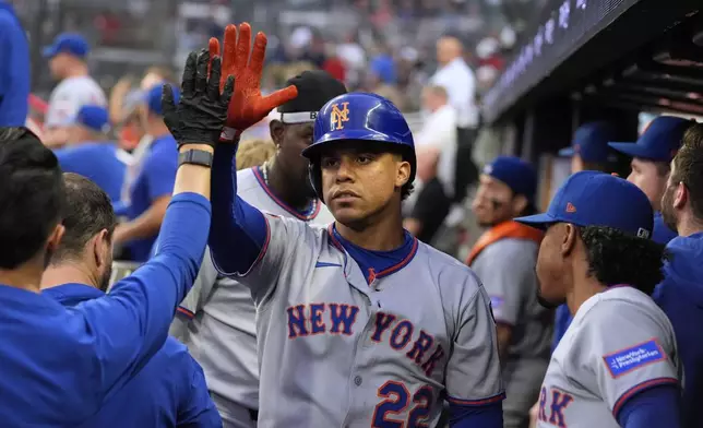 New York Mets' Juan Soto (22) celebrates his solo home run in the first inning of a baseball game against the Atlanta Braves, Tuesday, June 17, 2025, in Atlanta. (AP Photo/Brynn Anderson)