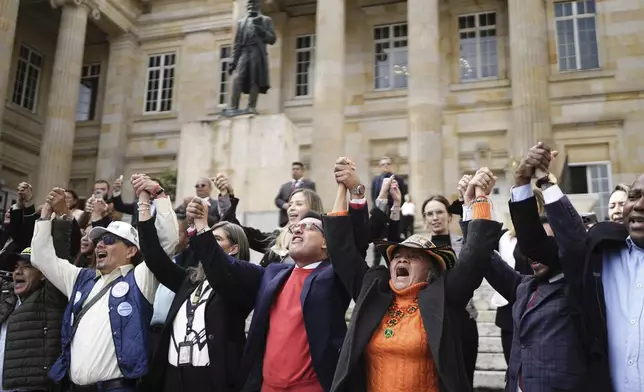 Lawmakers gather outside Congress to show support for Senator Miguel Uribe Turbay while he is in critical condition after being shot at a political rally in Bogota, Colombia, Monday, June 9, 2025. (AP Photo/Ivan Valencia)