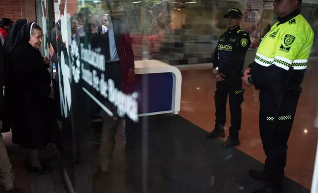 Nuns arrive to the clinic where Colombian Senator Miguel Uribe Turbay is being treated after he was shot at a political rally in Bogota, Colombia, Monday, June 9, 2025. (AP Photo/Ivan Valencia)