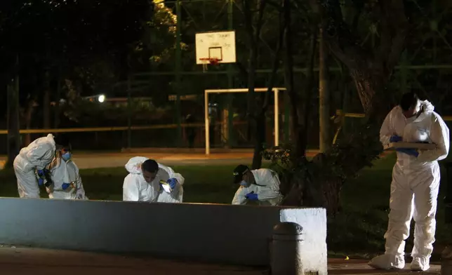 Investigators inspect the scene where Colombian senator and presidential candidate Miguel Uribe Turbay was shot during a campaign rally in Bogota, Colombia, Saturday, June 7, 2025. (AP Photo/Jhon Wilson Vizcaino)