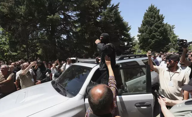 Armenian National Security Service officers arrive to arrest Mikael Ajapahyan, Archbishop of Gyumri and Shirak, at Echmiadzin, the seat of the Armenian Apostolic Church outside Yerevan, Armenia, Friday, June 27, 2025. (Hayk Baghdasaryan/Photolure via AP)