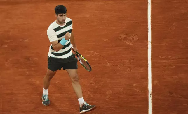 Spain's Carlos Alcaraz reacts as he plays against Italy's Lorenzo Musetti during their semifinal match of the French Tennis Open at the Roland-Garros stadium in Paris, Friday, June 6, 2025. (AP Photo/Aurelien Morissard)