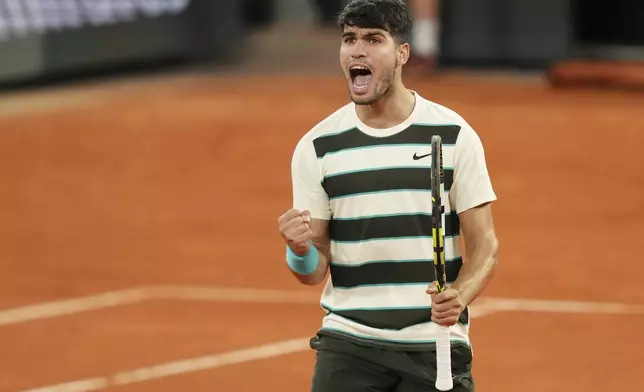 Spain's Carlos Alcaraz reacts as he plays against Italy's Lorenzo Musetti during their semifinal match of the French Tennis Open at the Roland-Garros stadium in Paris, Friday, June 6, 2025. (AP Photo/Aurelien Morissard)