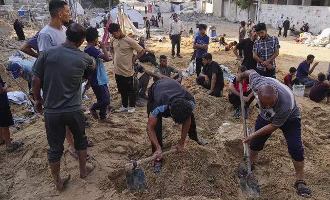 Palestinians dig through sand looking for belongings after an Israeli strike hit a displacement tent camp in Gaza City, Saturday, June 28, 2025. (AP Photo/Jehad Alshrafi)