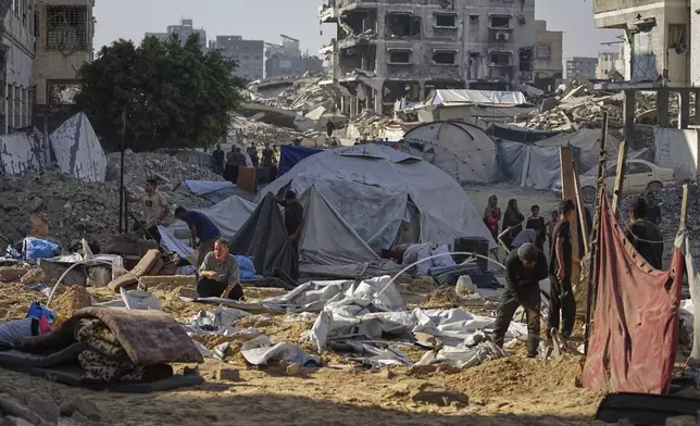 Palestinians inspect damaged tents after an Israeli strike hit a displacement camp in Gaza City, Saturday, June 28, 2025. (AP Photo/Jehad Alshrafi)