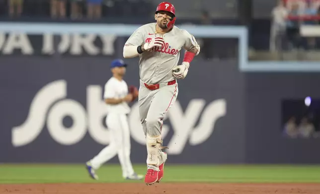 Philadelphia Phillies' Nick Castellanos rounds the bases after hitting a solo home run off Toronto Blue Jays pitcher Jose Berrios during the second inning of a baseball game in Toronto, Wednesday, June 4, 2025. (Chris Young/The Canadian Press via AP)