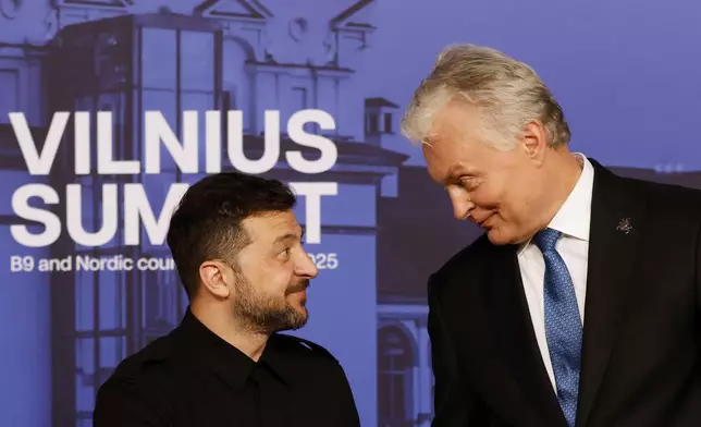 Lithuania's President Gitanas Nauseda, right, welcomes Ukraine's President Volodymyr Zelenskyy during arrivals for the Vilnius Summit at the Palace of the Grand Dukes of Lithuania in Vilnius, Lithuania, Monday, June 2, 2025. (AP Photo/Mindaugas Kulbis)